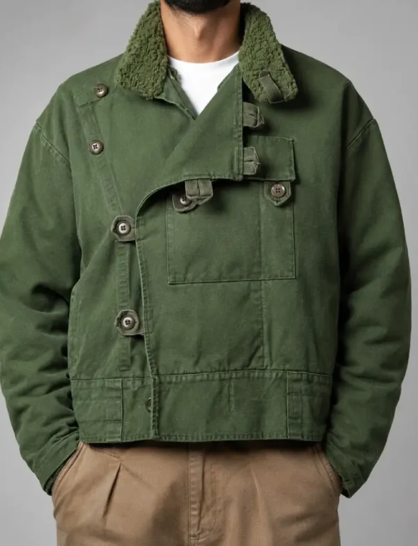 A model wearing 1960 Swedish Army Motorcycle Jacket with beige pants.